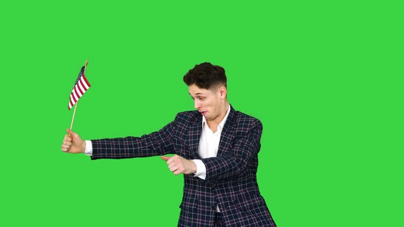 Young Man in Formal Suit Dancing in a Funny Way with American Flag on a Green Screen, Chroma Key alt