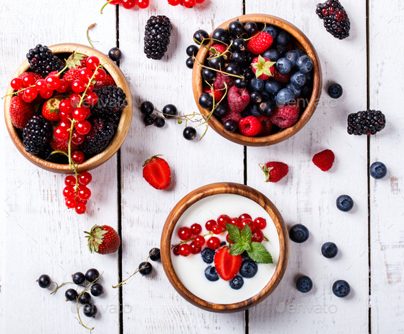 Homemade Yogurt,bowl with different berries,blackberries, strawberries,red currants,raspberries - Stock Photo - Images
