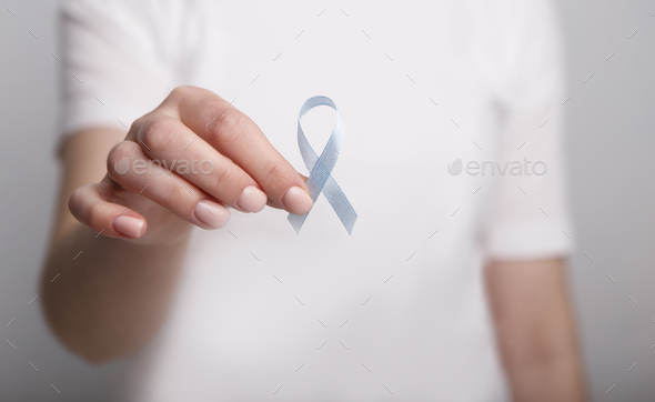 Woman holding Blue ribbon, Child Abuse awareness - Stock Photo - Images
