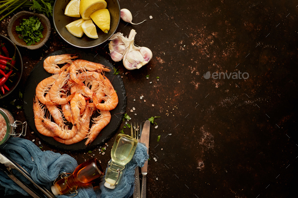 Seafood composition with shrimps or prawns. Seved on dark background with many ingredients. Flat lay - Stock Photo - Images