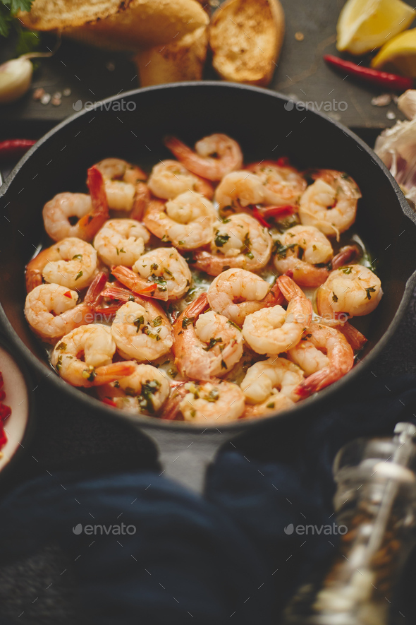 Tasty shrimp tails fried in butter with, garlic, parsley, white wine chili. With various ingredients - Stock Photo - Images