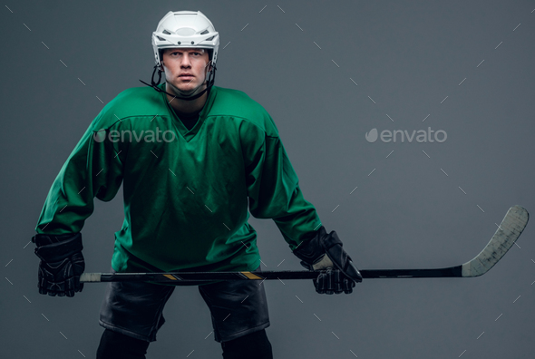 Hockey player holds gaming stick.