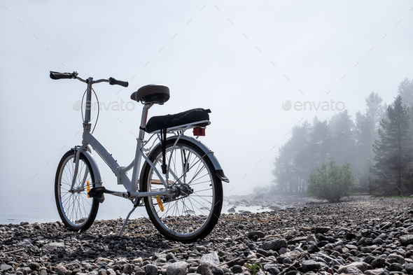 Bicycle on natural rocky beach outdoors background.