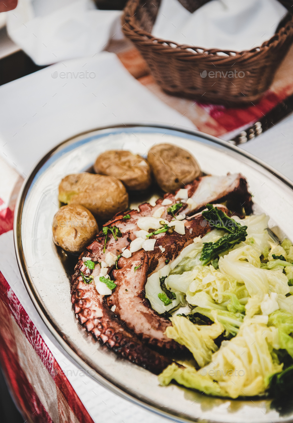 Traditional portuguese dish with grilled octopus, boiled potato and cabbage - Stock Photo - Images