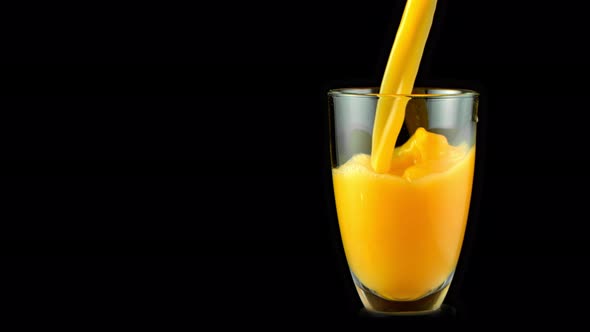 Super Slow Motion Shot of Pouring Fresh Orange Juice Into Glass at 1000 Fps alt