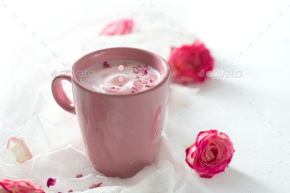 Moon milk prepares with pink rose flower. Trendy relaxing bedtime drink form Ayurvedic traditions