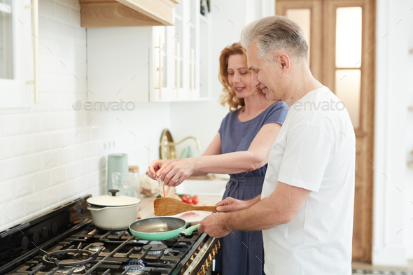 Happy Mature Couple Cooking Together at Home