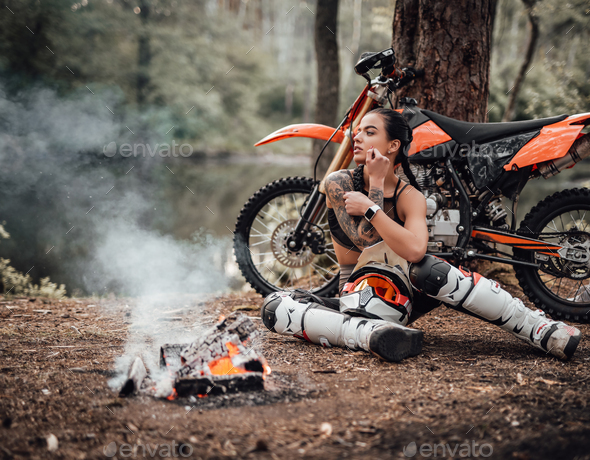 Young female motocross racer wearing motocross outfit with semi naked torso  Stock Photo by fxquadro