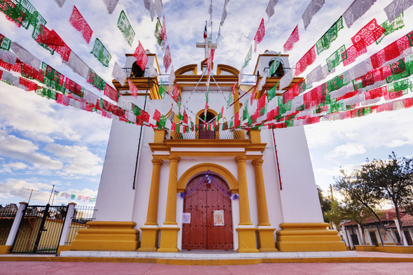 Red, white and green banners on church, Chiapas, Mexico