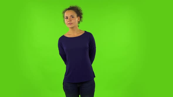 Curly Woman Standing in Front of the Camera, Saying Oh My God and Being Shocked. Green Screen alt