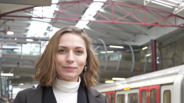 Slow motion shot of smiling woman at station