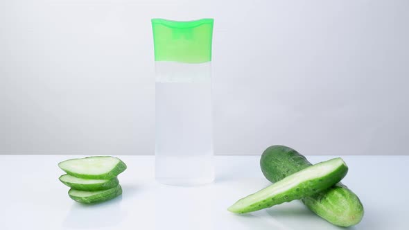a Woman's Hand Puts Takes From the Table on Which Lies a Cucumber a Tube with a Refreshing Cucumber