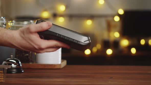 Paying with Smartphone Closeup Using NFC Technology in a Restaurant alt