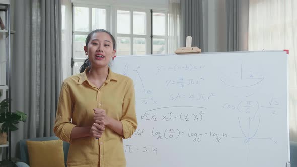 Asian Female Teacher With Marker Pen Teaching Math At Home alt
