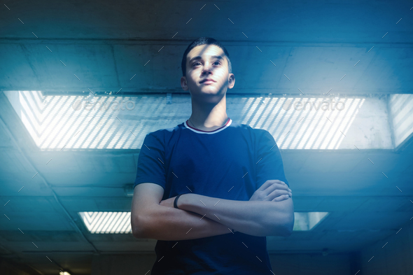 Young teenage boy posing underground in a subway - Stock Photo - Images
