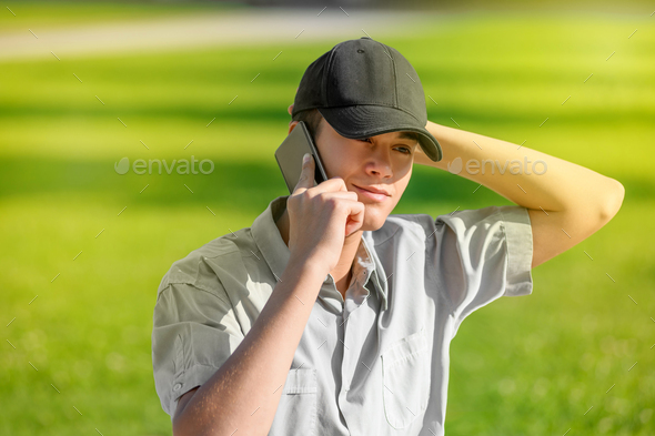 Trendy young teenage boy using his smartphone - Stock Photo - Images