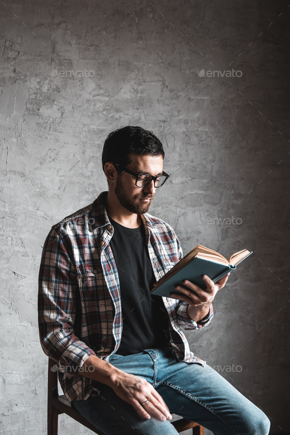 Man reading. Book in his hands. education, development, knowledge - Stock Photo - Images