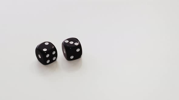 Male Hands Throwing Double Dice on White Table. Two and Three on Dice Cubes at Playing Table alt