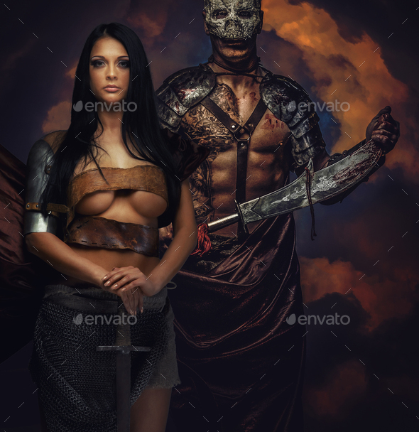 Female and male in armor and swords - Stock Photo - Images