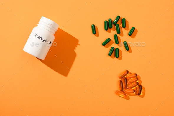 Top View of Container With Omega-3 Lettering And Capsules on Orange
