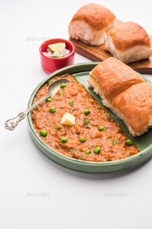Pav bhaji is a popular Indian street food that consists of a spicy mix vegetable mash & soft buns - Stock Photo - Images
