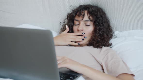Tired Girl Remote Worker Using Laptop Computer in Bed Then Yawning and Sleeping alt