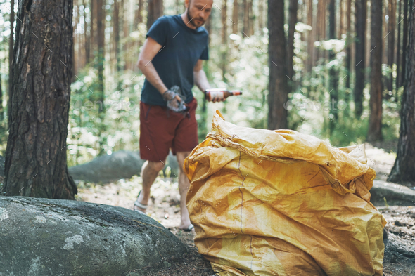 Big garbage bag in the woods. Picking up trash in the forest Stock Photo by  GalinkaZhi