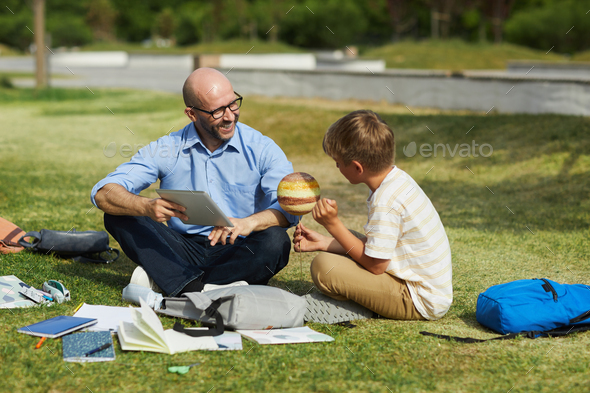 Boy Talking to Teacher during Outdoor Lesson