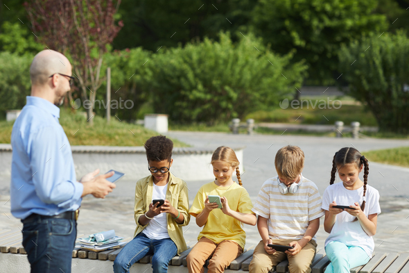 Kids Using Gadgets during Outdoor Lesson