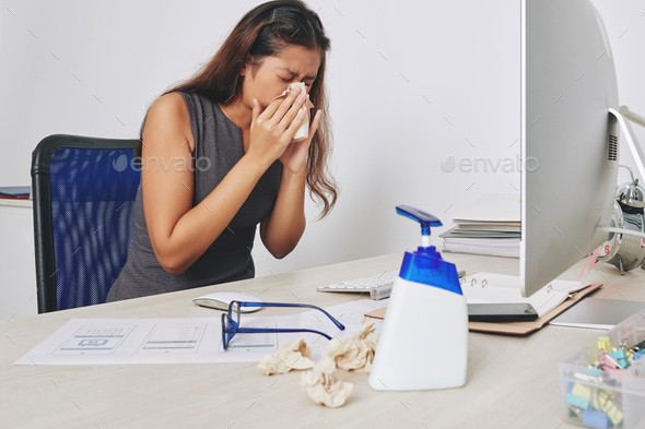 Sneezing businesswoman