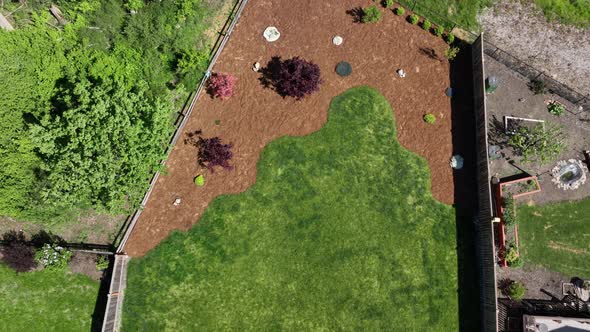 Top down aerial shot of a yard with beautiful bark and landscaping. alt