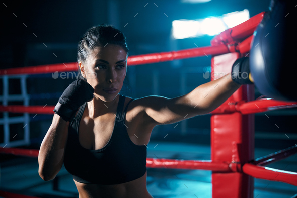 Female fighter hitting small boxing bag