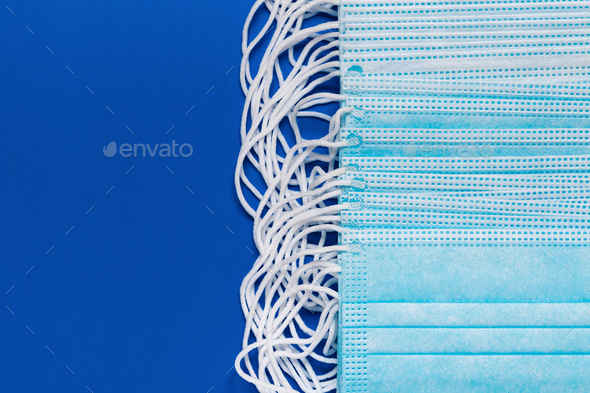 Close-Up View of Lot Surgery and Medical Face Masks on Classic Blue Color Background - Stock Photo - Images
