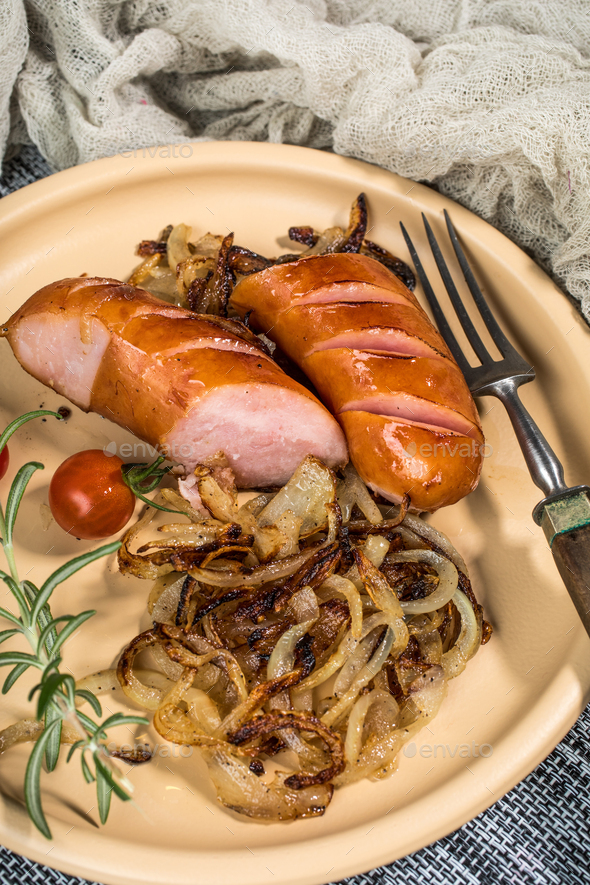 Fried sausage with onion. Stock Photo by foto_pstryki PhotoDune