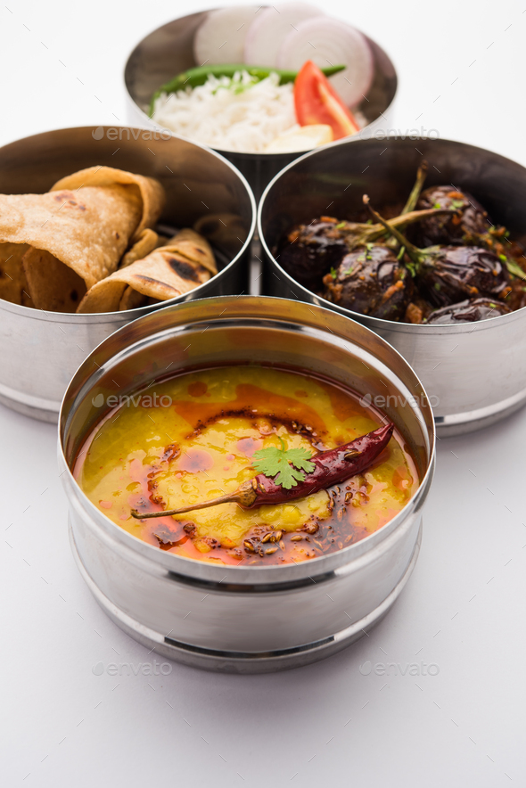 Indian Veg Lunchbox for office of workplace with Baingan Masala, dal fry rice and chapati - Stock Photo - Images