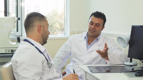 Happy Doctors Discuss Something and Laugh alt