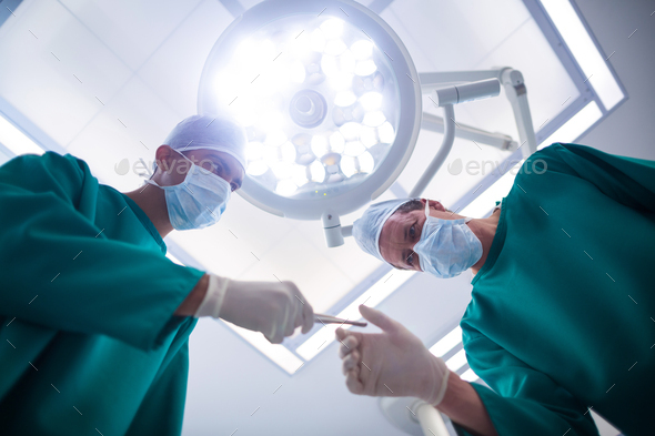Surgeons operating in operation theater - Stock Photo - Images