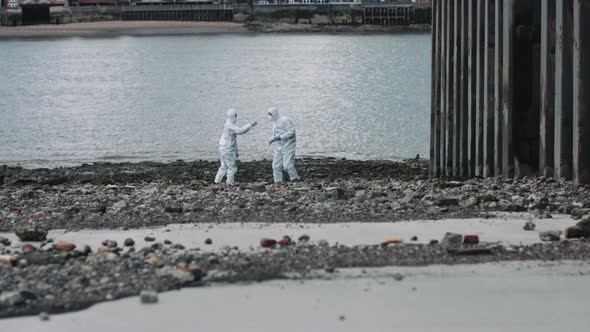 Forensic scientist taking sample at river bank