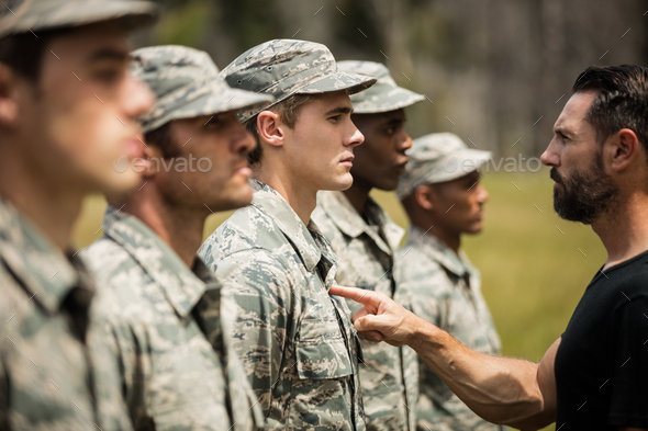 Trainer giving training to military soldier Stock Photo by Wavebreakmedia