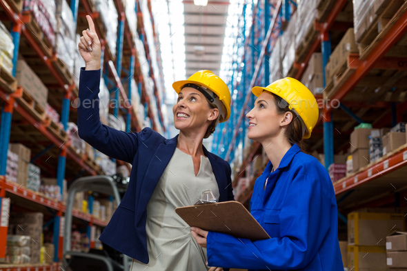 Warehouse manager and worker checking the inventory - Stock Photo - Images