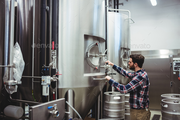Male manufacturer working at brewery - Stock Photo - Images