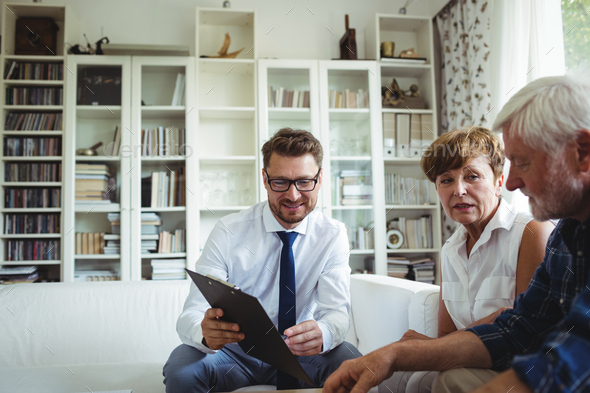 Senior couple planning their investments with financial advisor - Stock Photo - Images