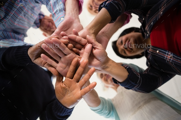 Directly below shot of senior friends stacking hands - Stock Photo - Images