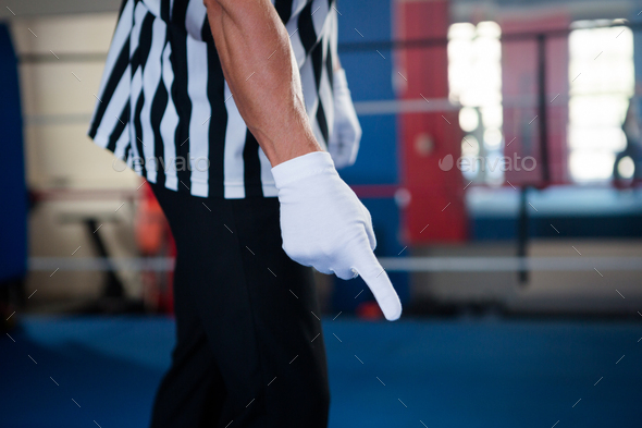 Midsection of male referee pointing down