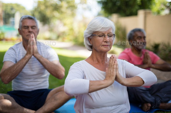 Senior People With Closed Eyes Meditating In Prayer Position Stock