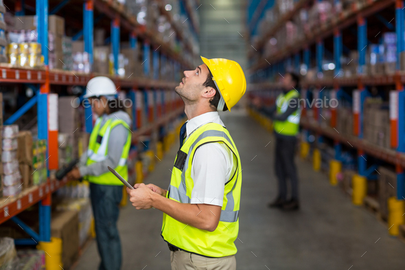 Warehouse manager looking at packages - Stock Photo - Images
