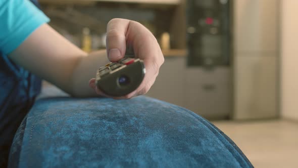 Man Picks Up a Remote Control and Switches Channels Presses Buttons Camera Movement alt