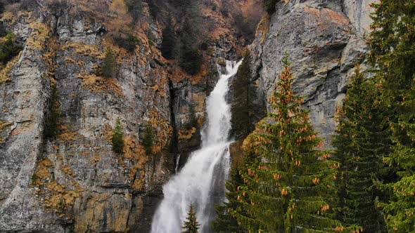 Aerial view over a big waterfall in the mountain forest. Beautiful nature landscape alt