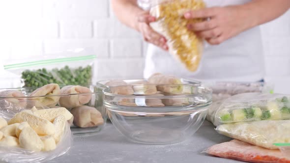 Frozen food. Frozen corn is poured from plastic bag into the glass bowl