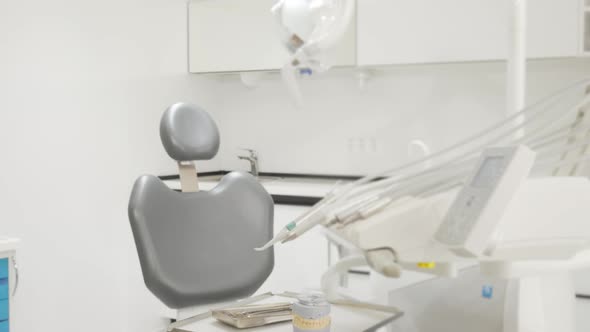 Young Woman Getting Into Dental Chair Smiling To the Camera